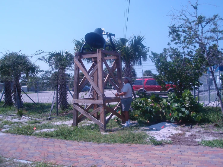 an old fashioned life size wooden tower with a couple of people on it