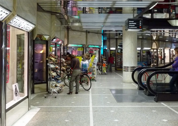 people in a store with their bicycles and various types of shoes