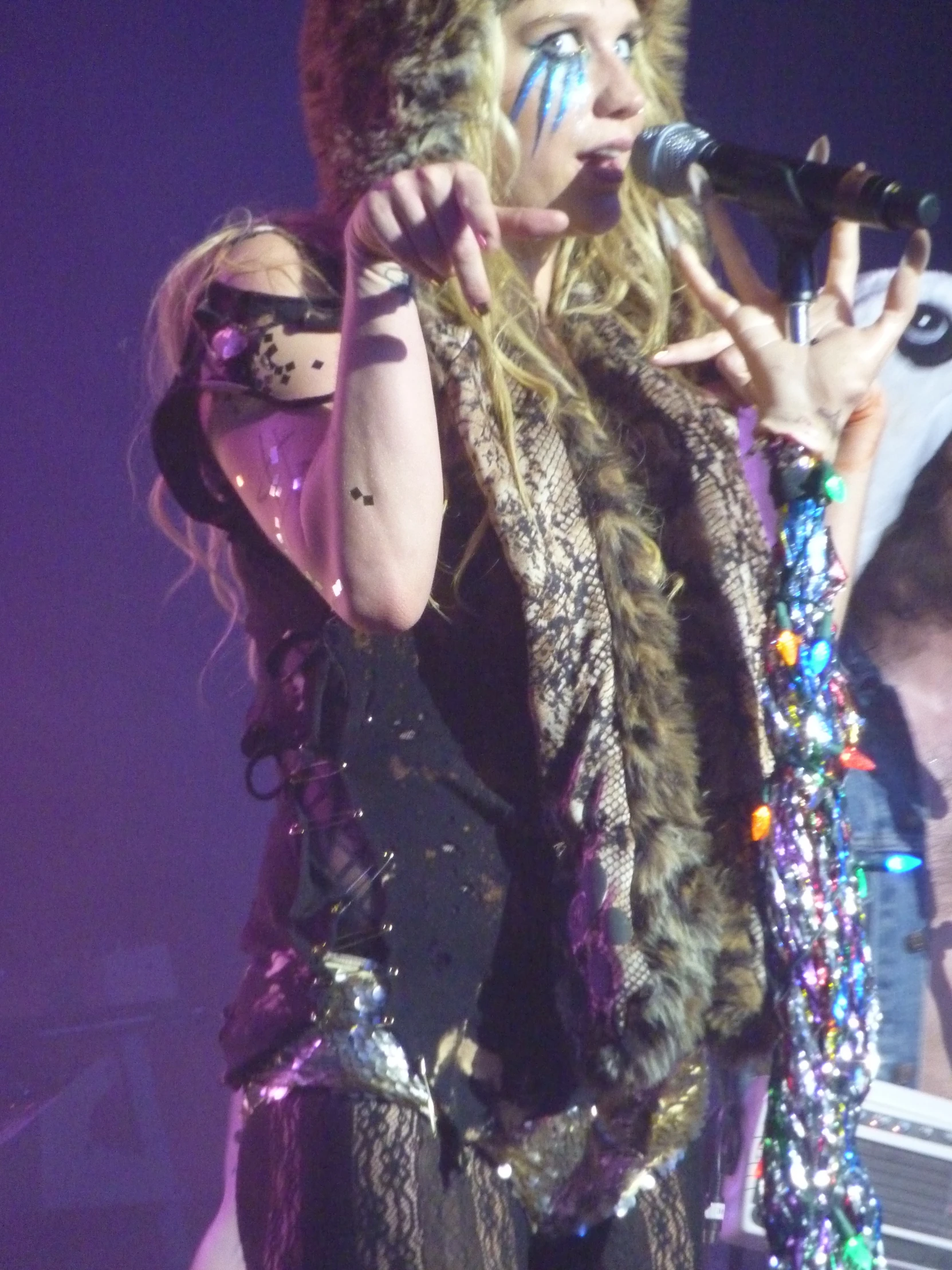 a woman on stage holding her microphone up