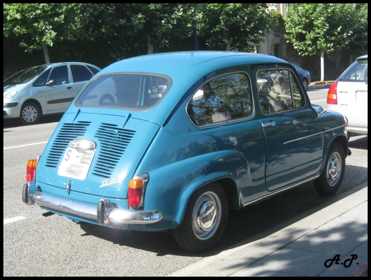 the old volkswagen type car is blue with a license