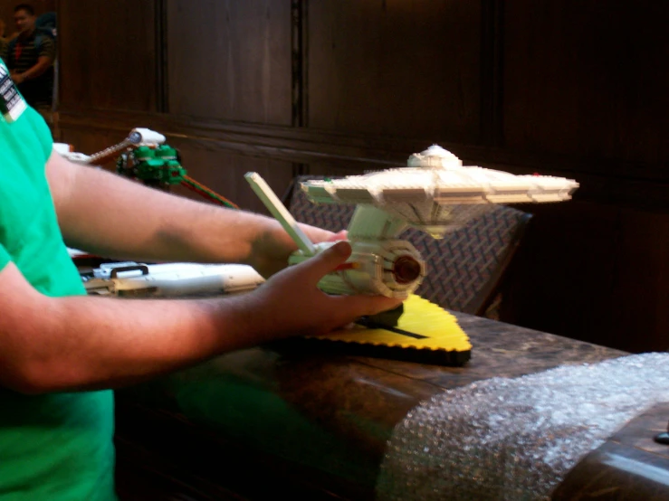 a man standing next to a model of a plane