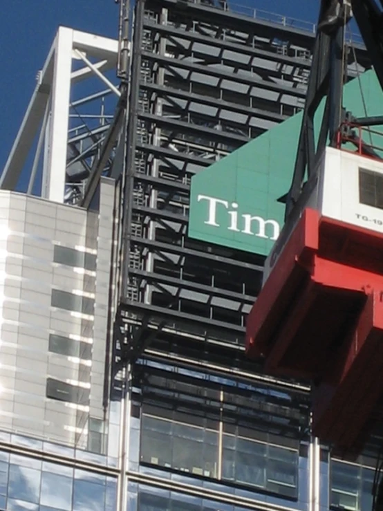 a crane is lifted over the tim building