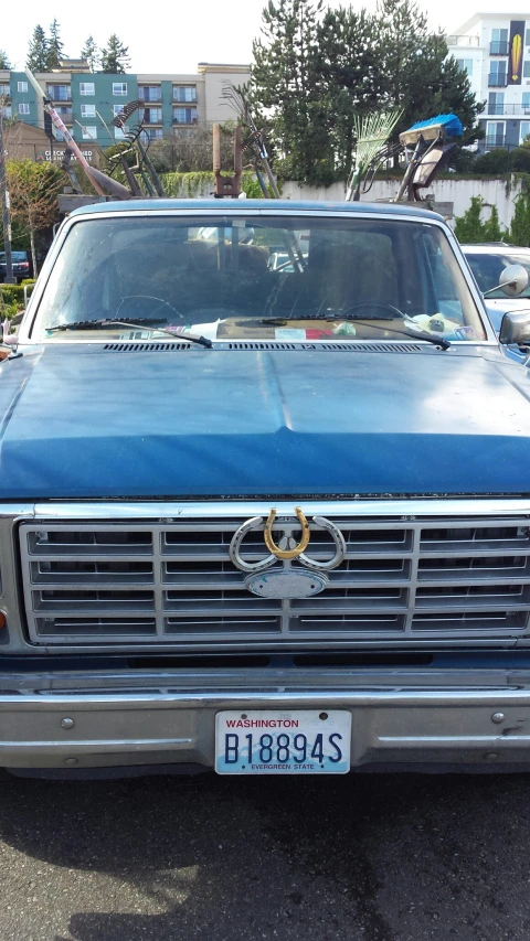 an old blue truck with a flat head grille and hood