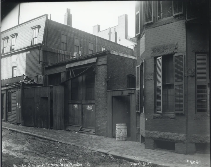 a row of small buildings with wood doors