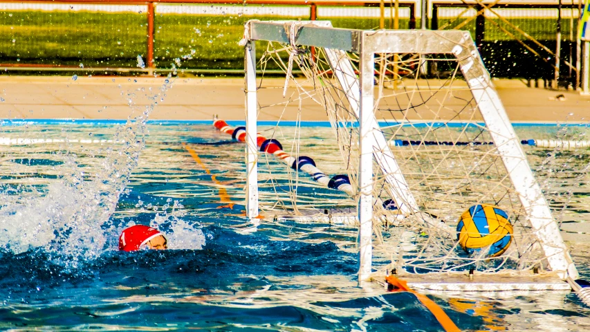 water polo goalie jumping in to the pool during a game