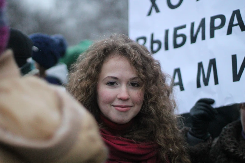woman with a sign in front of her during a protest