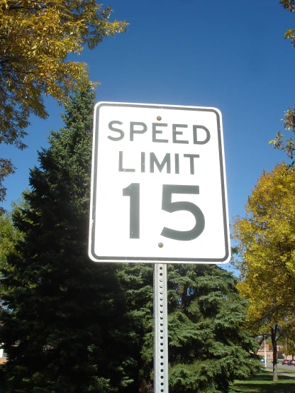 a street sign with the word speed limit 15 below it