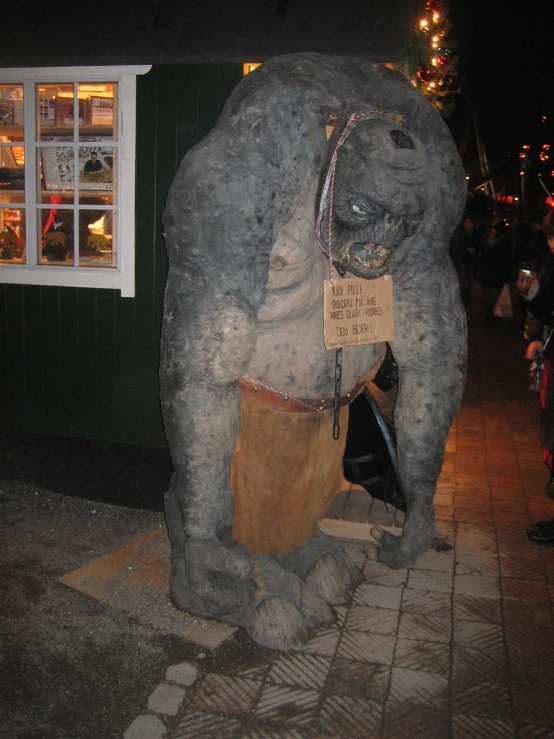 there is a statue of a man in front of a business