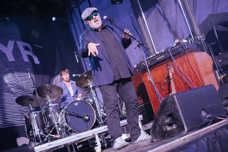 a band on stage with one man on the keyboards