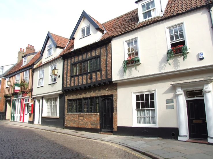 a building in front of a brick street next to buildings