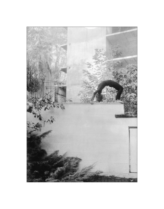 black and white pograph of a person jumping in the air with a skateboard