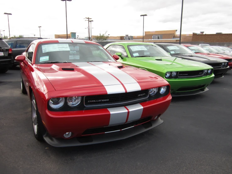 many cars lined up side by side in parking lot