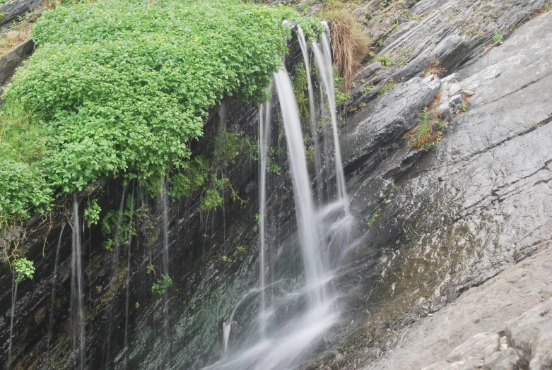 small waterfall cascading over the edge of a cliff