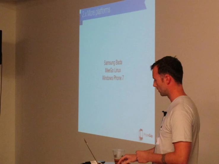 a man in white shirt using a projection screen