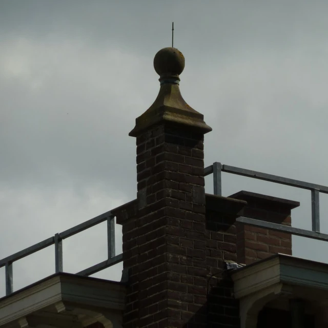 a weather vane on top of a brick building