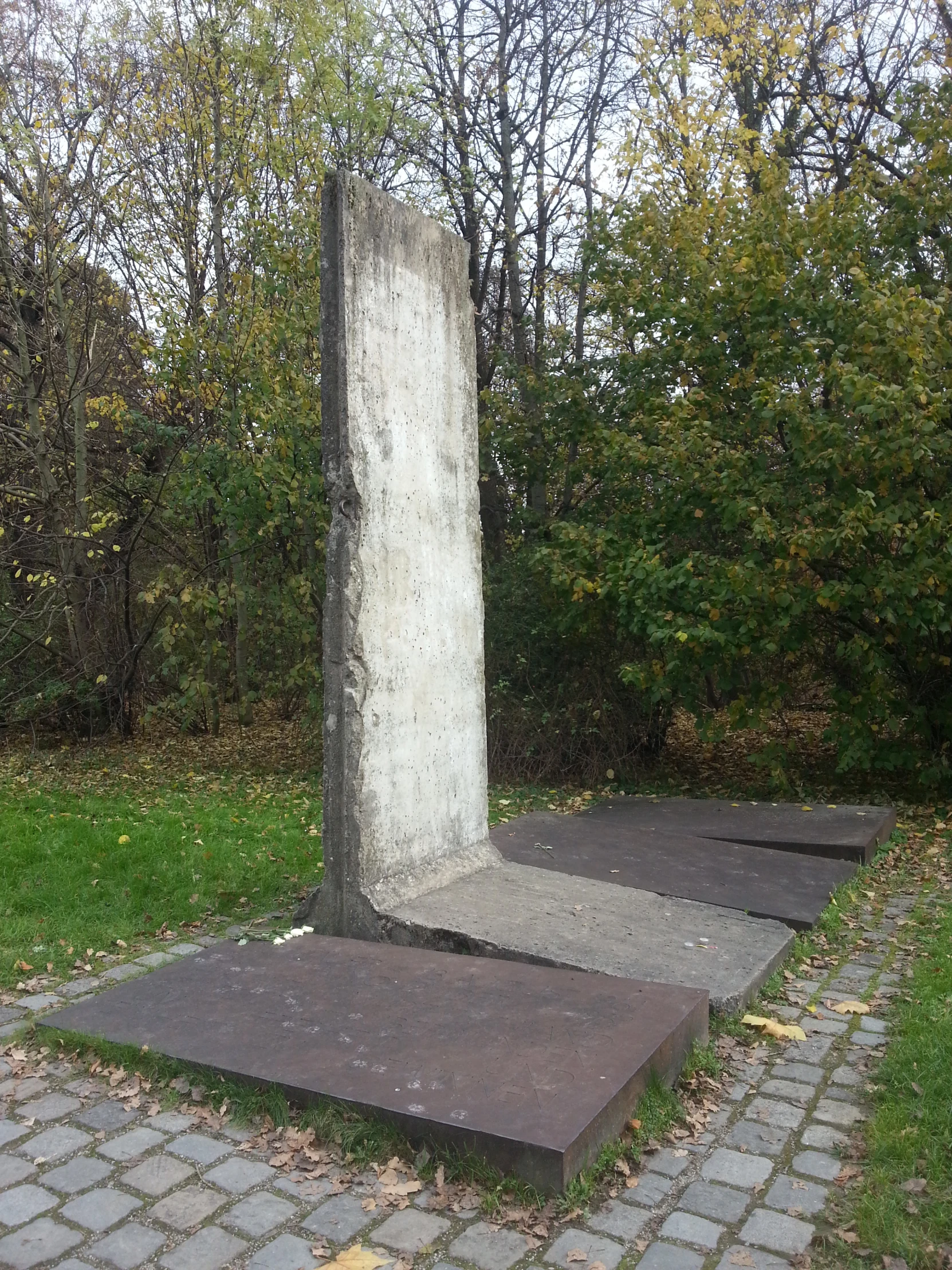 a stone sculpture sits on an empty field