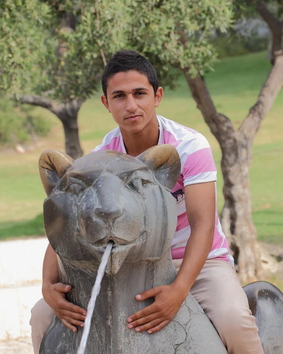 a person sitting on top of a statue with a horse