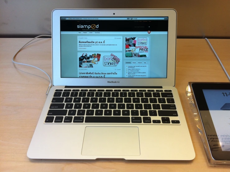 an open laptop computer sitting on top of a wooden desk