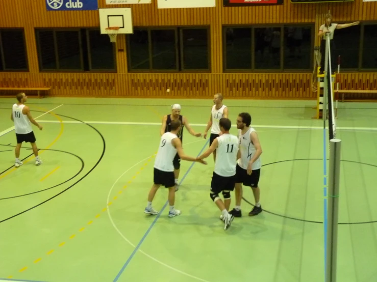 an image of a group of men playing volleyball together