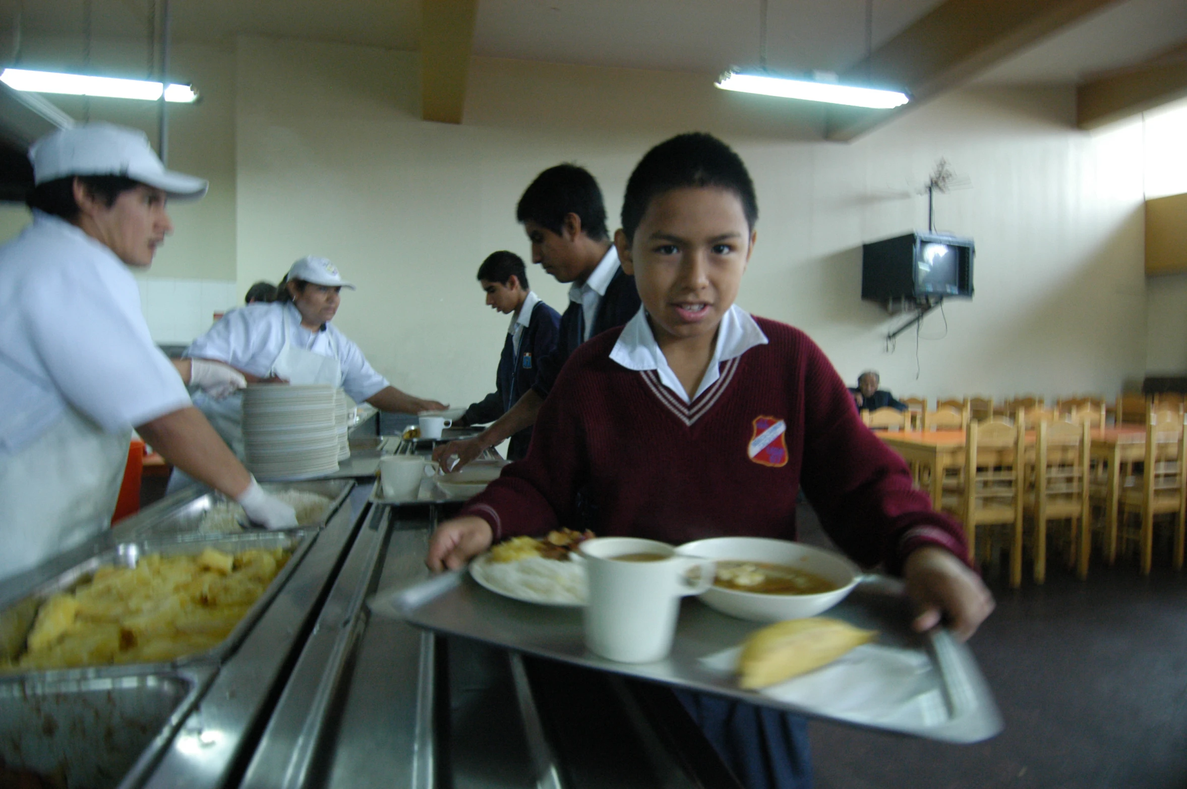 a young man serving out a variety of food