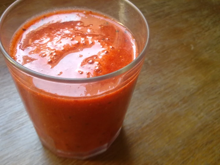 a close up of a drink in a glass on a table