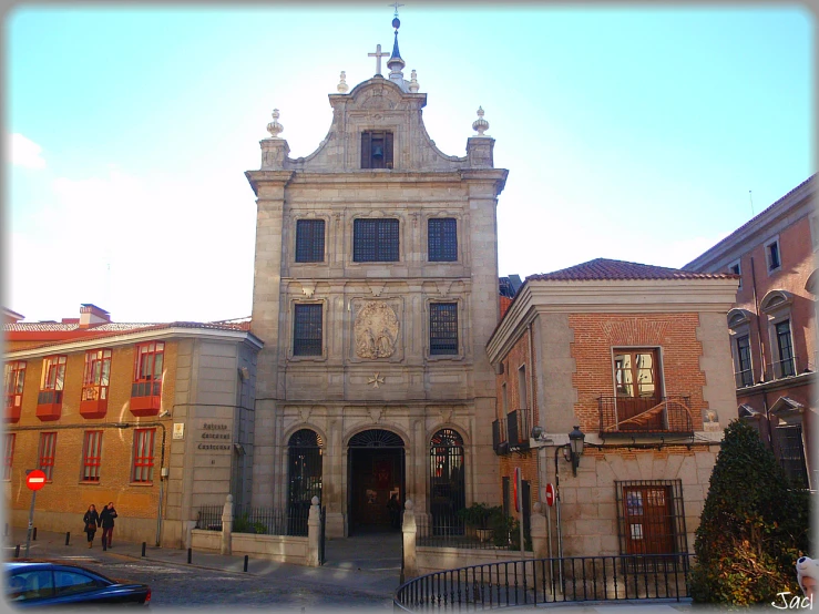 an old castle type building with a lot of windows and a clock on the side