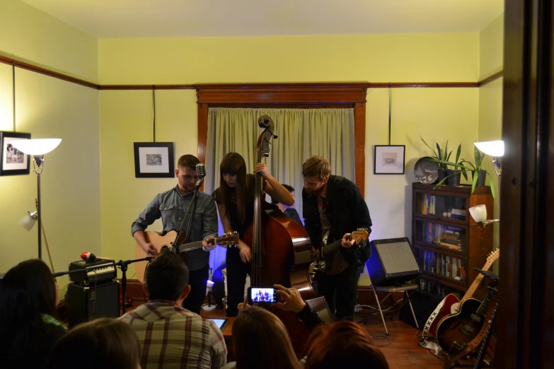 a group of people in a room with guitars