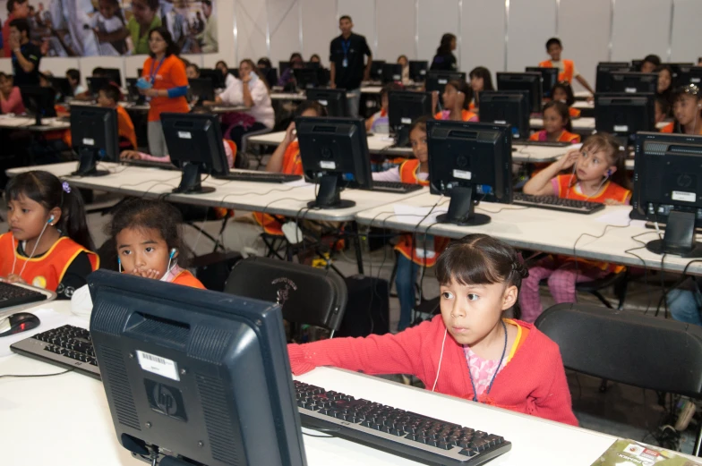 an empty room with many computer screens sitting in front of people