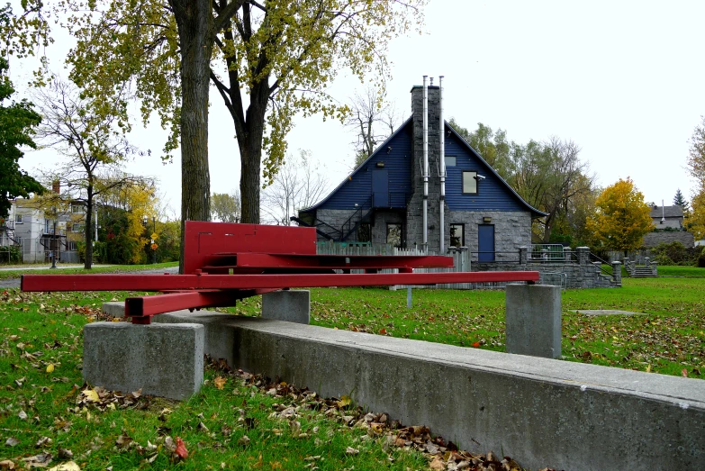 an image of a red bench outside on the grass