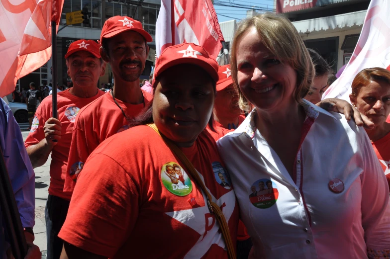 a woman poses for a picture with a group of people