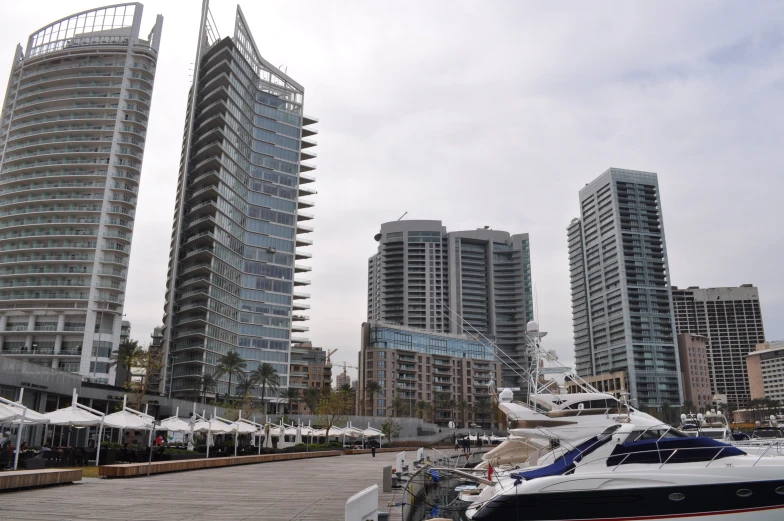 the boats are parked in the marina next to the large building