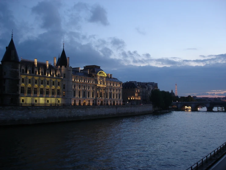 a river with buildings on the banks, and a bridge