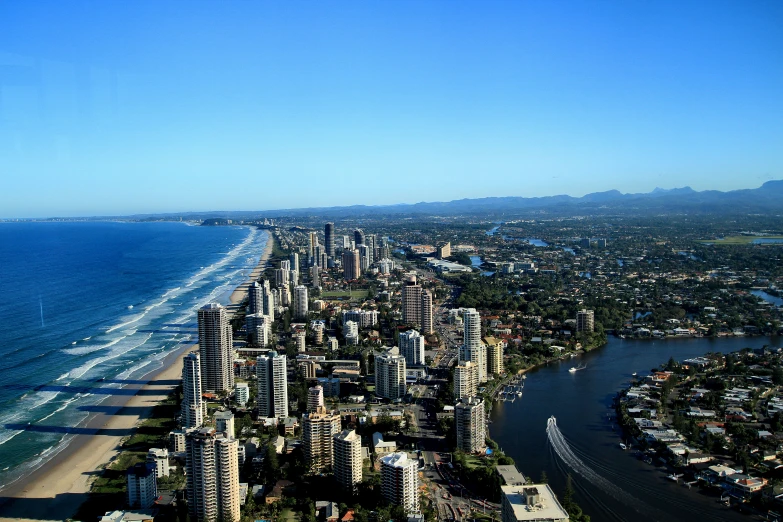 a bird's eye view of the ocean and a very wide city