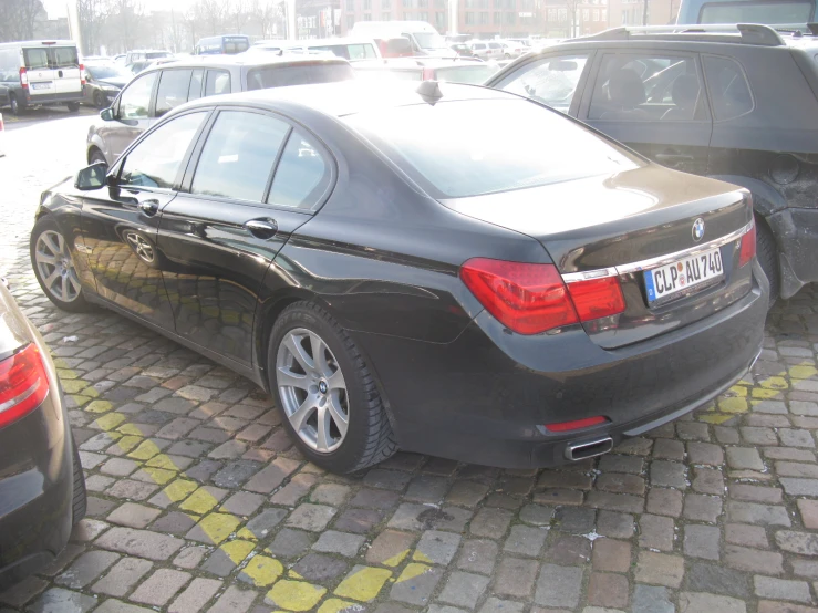 black car parked near a parking lot on the street