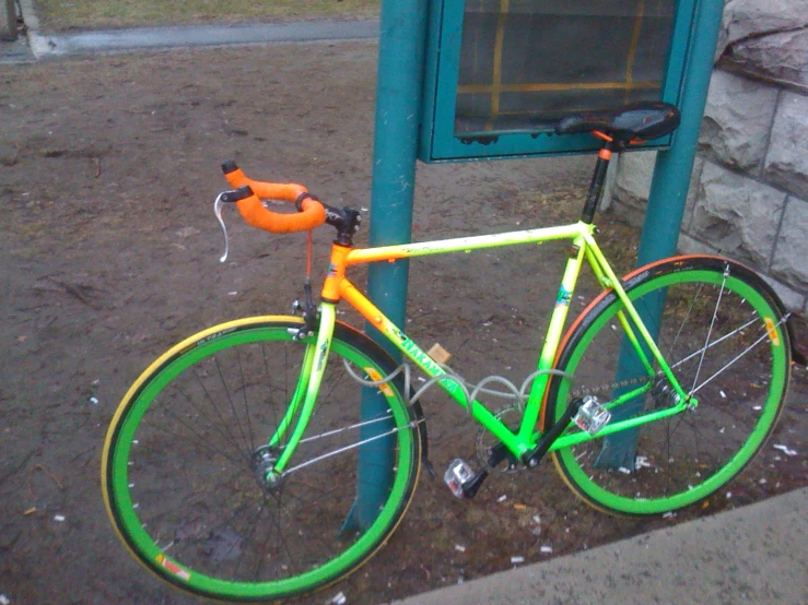 an orange and green bike with the word orange on the side