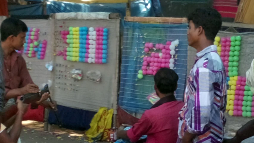 a man holding an item in his hand at the market