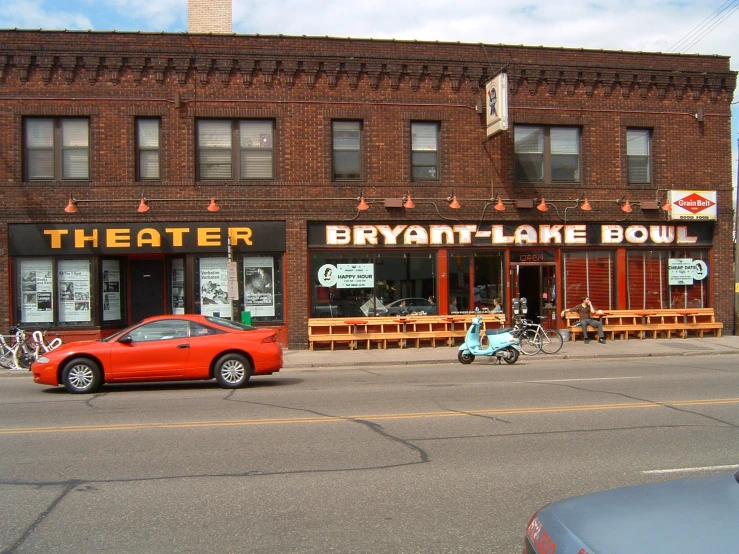 a car is parked in front of a theater