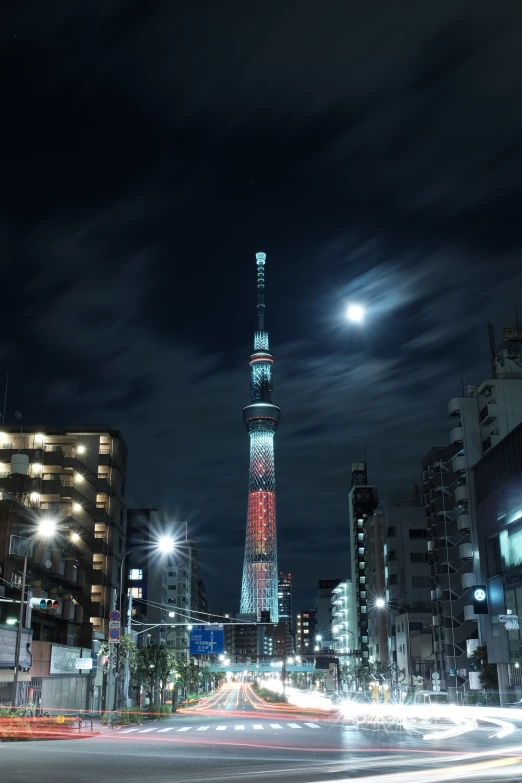 a night view of a city street with skyscrs