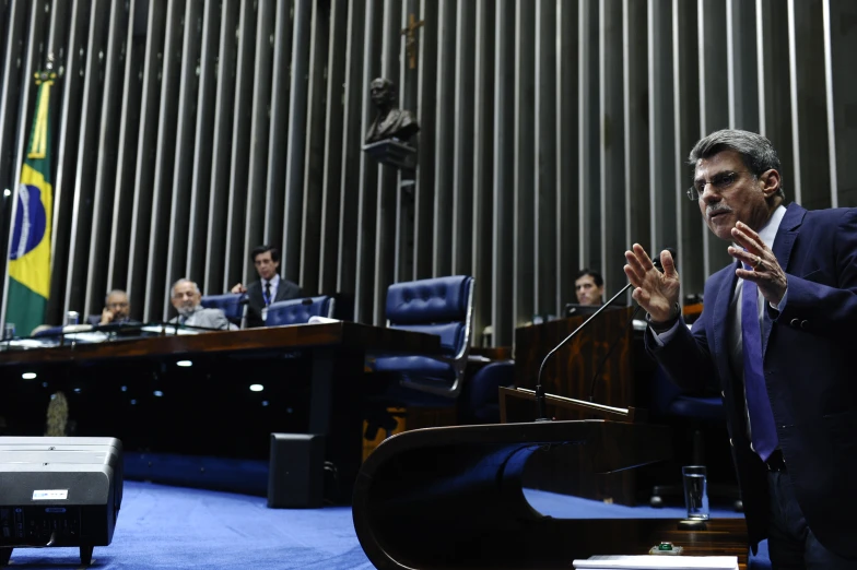 two men standing at podiums speaking in a business meeting