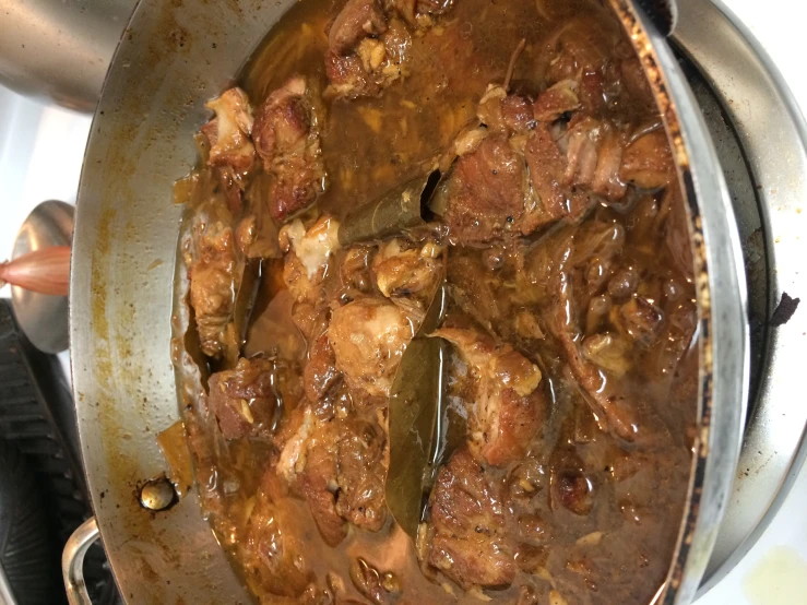 stew sitting on the stove with a spoon