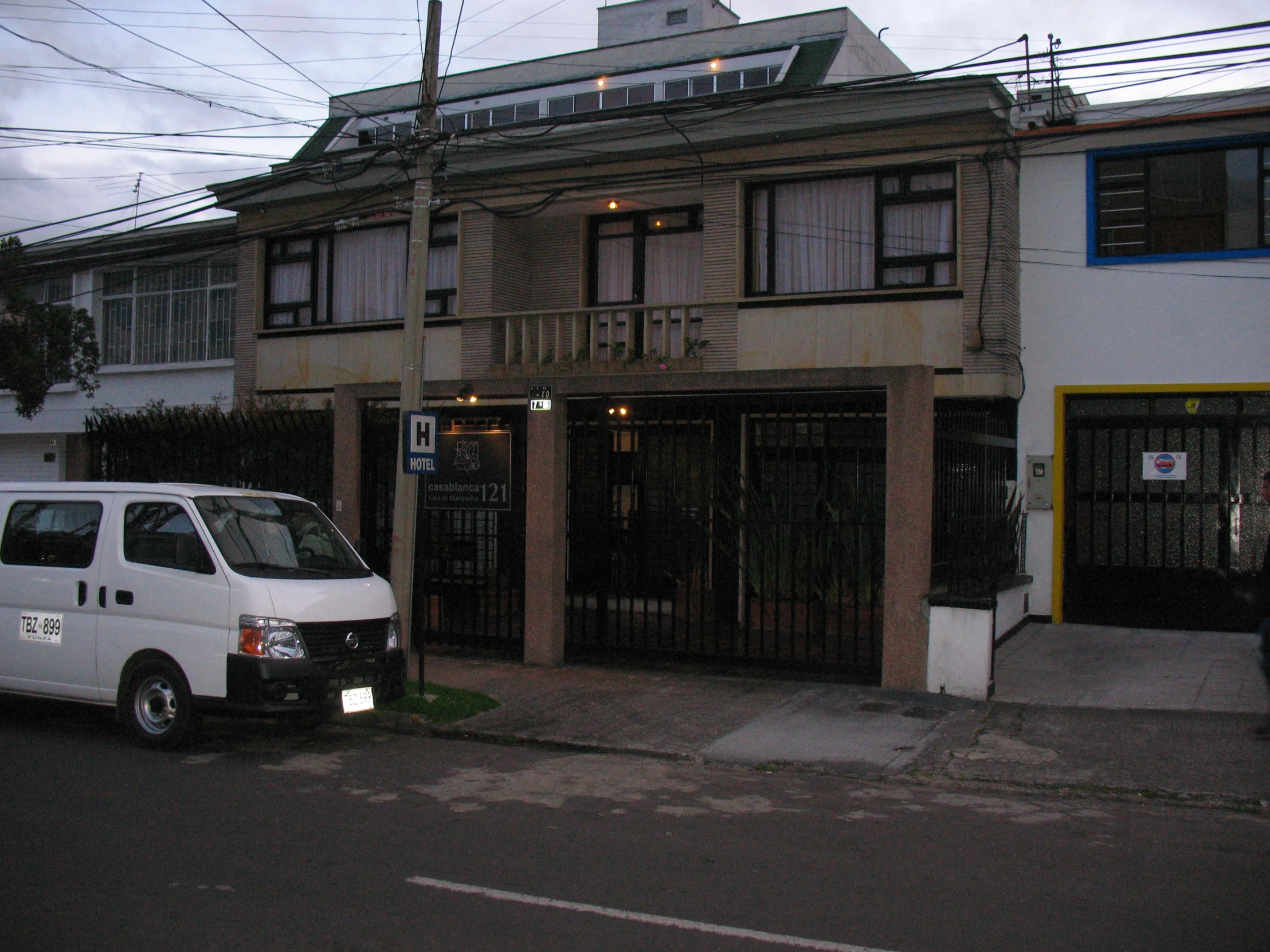 a white van is parked in front of two homes