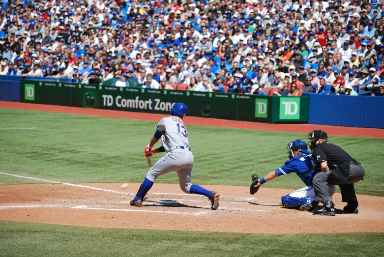 the baseball player is about to run after hitting the ball