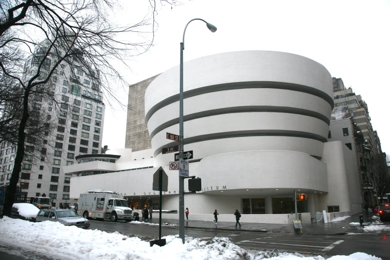 snow covers the ground around the architectural building