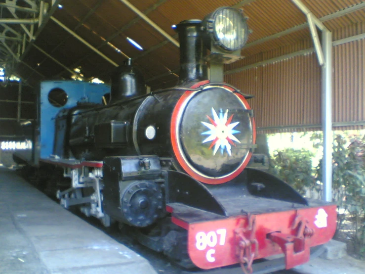 a train in a station sitting on the tracks