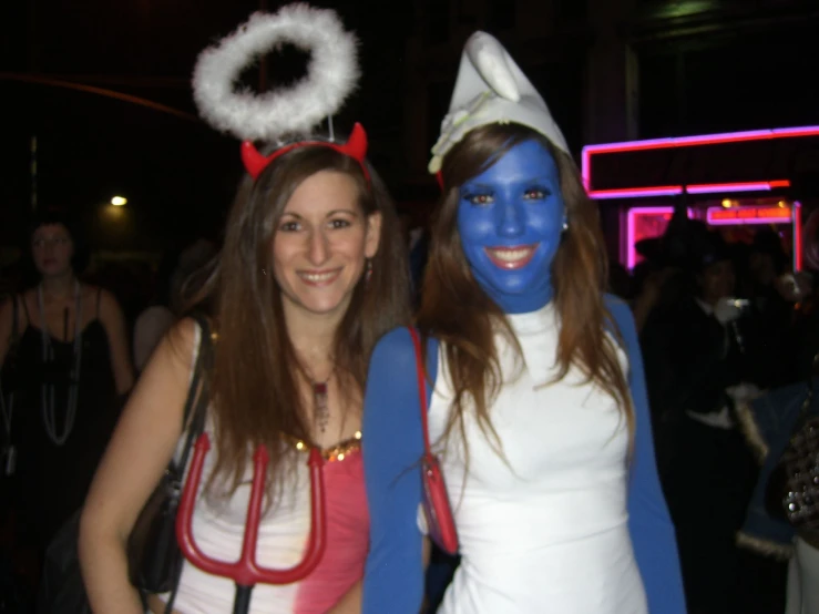 two women in costume at a party posing for a po