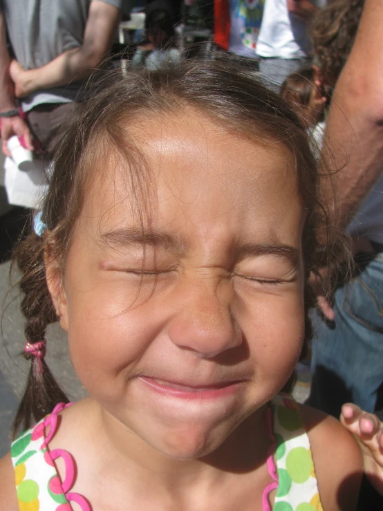 a  wearing a dress smiling for the camera