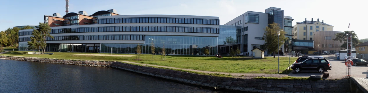 a building along the river has a long walkway