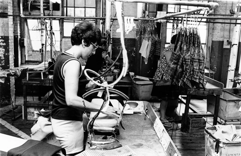 a person in a factory sewing some material