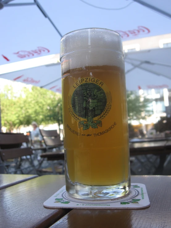 a drink sits in front of an umbrella in a restaurant