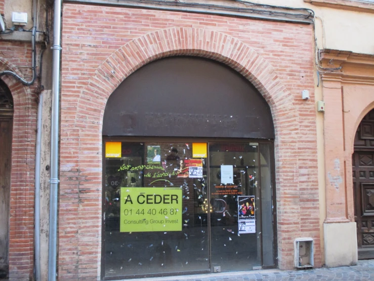 an arched doorway that leads into a museum with several pictures on it